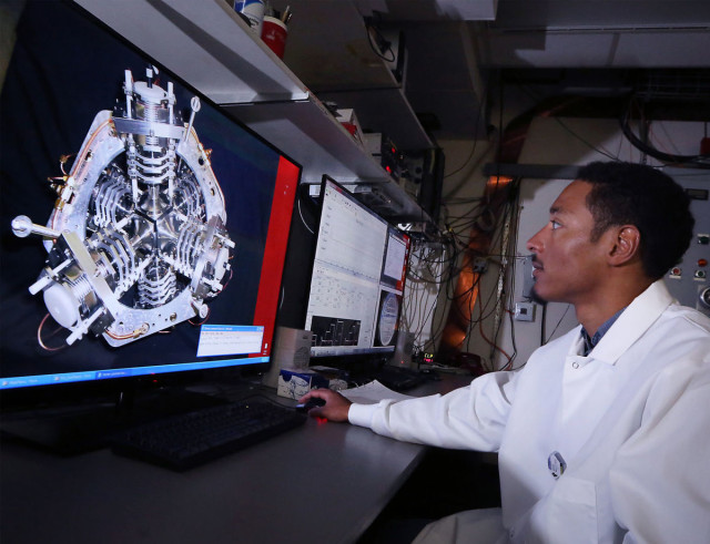 Researcher Aaron Olson views an experiment with a neutron source that is the key part of new drone technology he helped develop