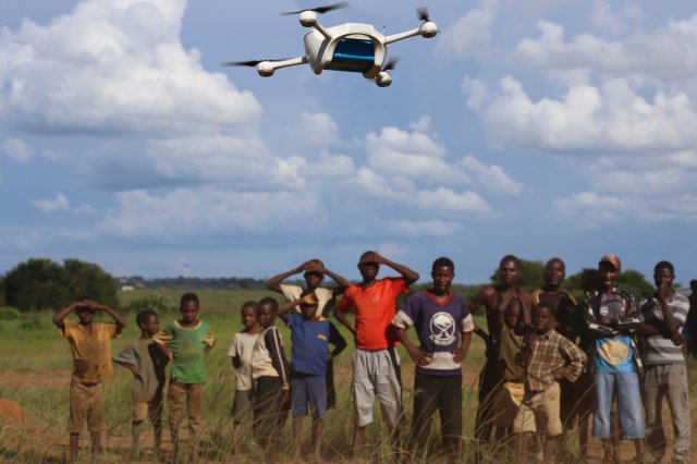 On 12 March 2016, children in Malawi look on amazed in the community demonstration of Unmanned Aerial Vehicles (UAVs or drones) flying in Lilongwe. The Ministry of Health and UNICEF launched the first 10km auto programmed flight in a trial to speed up...